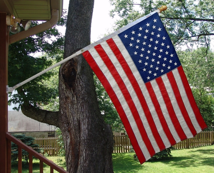 Mounted flagpole to side of house