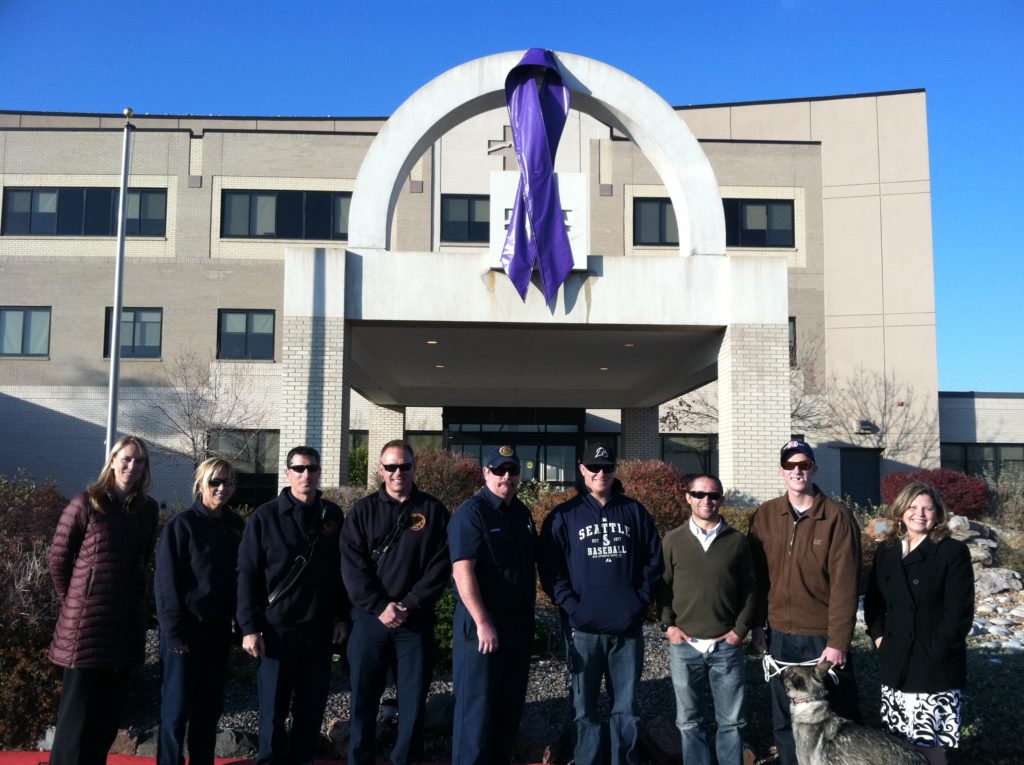 Custom flag company team hanging Jessica Ridgeways purple ribbon - a very special banner