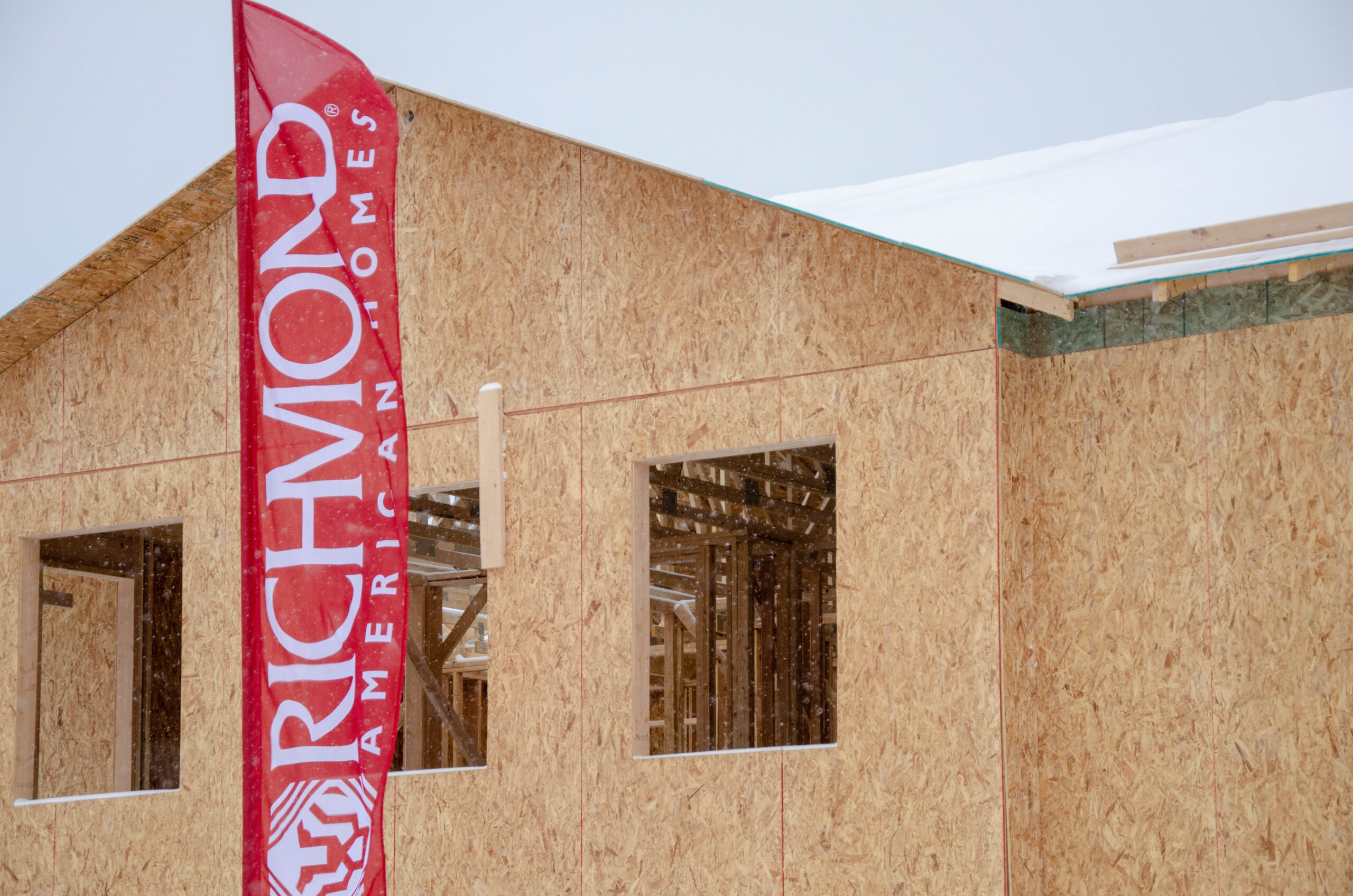 Custom Flag Company Richmond American Homes Custom Feather Flag 1 in front of new build